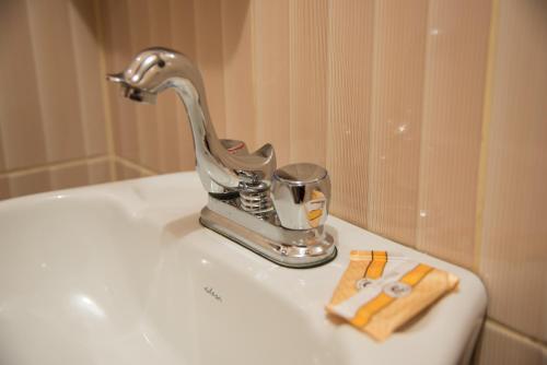 a bathroom sink with a faucet on a sink at HOSTAL MILAGROS INN - samary inn in Puno