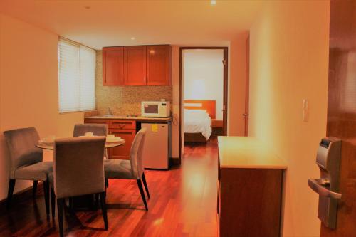 a kitchen and dining room with a table and chairs at Condesa Suites in Mexico City