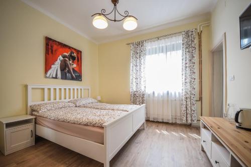 a bedroom with a large bed and a large window at Apartments Maria in Ljubljana