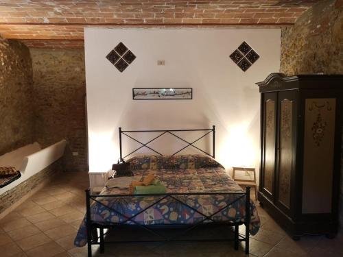 a bedroom with a bed in a room at Le Casette in Guardistallo