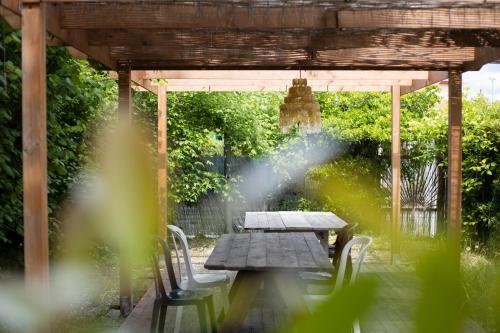 a picnic table under a pergola with a water fountain at Camping Dolce Sole in Marina di Massa