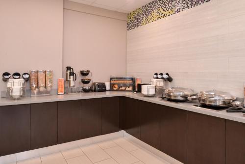 a kitchen with a counter with pots and pans at La Quinta by Wyndham Indianapolis South in Indianapolis