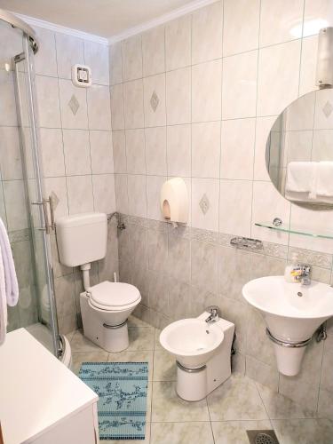 a bathroom with a toilet and a sink at DCK Apartments in Kostrena