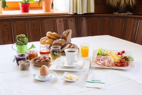 a table with a plate of breakfast food on it at Kristemoarhof in Lavant