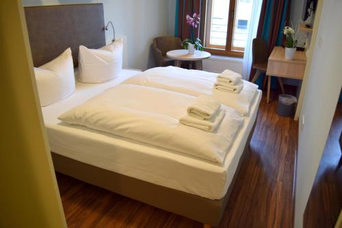 a bedroom with a bed with two towels on it at Trip Inn Residence City Center in Frankfurt/Main