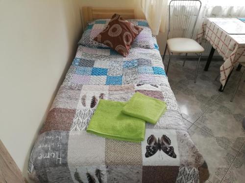 a bed with a quilt on top of it at Pokoje gościnne Zenon Nogal in Świnoujście