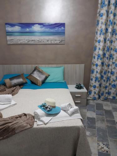 a bedroom with a bed with towels on it at la Villetta in Sciacca