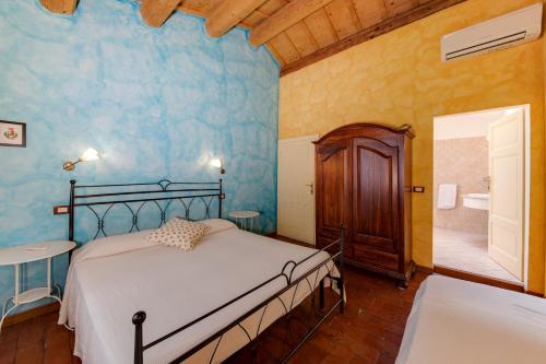 a bedroom with a bed and a bathroom with a tub at La Vecchia Stazione Ravenna in Ravenna
