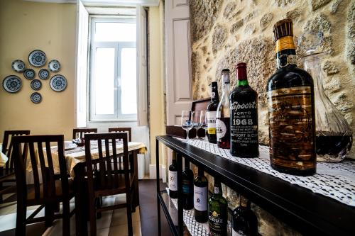 a bar with a bunch of bottles of wine at Dukes Corner Guest House in Porto