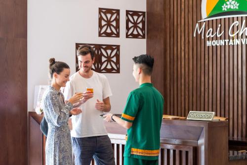 a man and a woman standing in a room at Mai Chau Mountain View Resort in Mai Chau