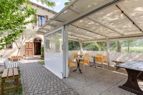 a white pergola with a table and chairs at La Vecchia Stazione Ravenna in Ravenna