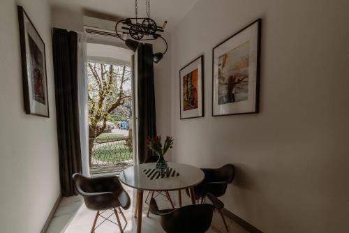 a dining room with a table and chairs and a window at BIKE ROOMS in Przemyśl