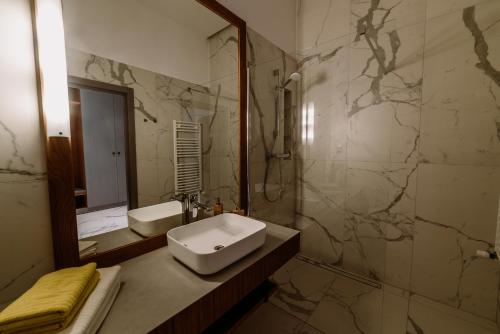 a bathroom with a sink and a mirror at BIKE ROOMS in Przemyśl