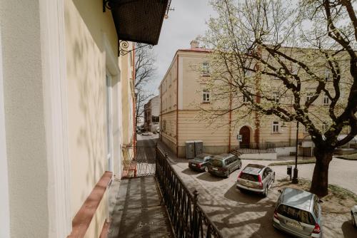 a balcony of a building with cars parked in a parking lot at BIKE ROOMS in Przemyśl