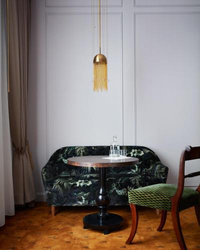 a table and a couch in a living room at Maison Metier, in the Unbound Collection by Hyatt in New Orleans