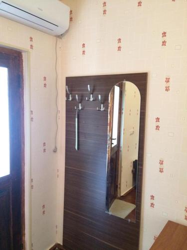 a bathroom with a mirror on the wall at Huseyn Houses in Ganja