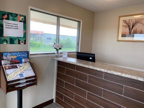 an empty waiting room with a counter and a window at Regency Inn in Rolla