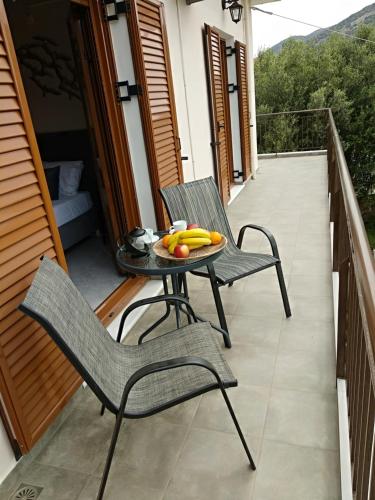 a table with bananas and fruit on a balcony at Cephalonian Countryside Villa in Divarata
