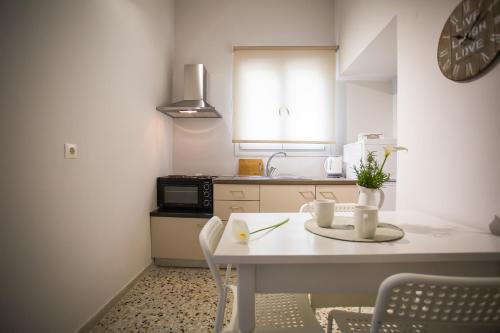 a small kitchen with a table and a counter top at Fotini's House in Ýpsos