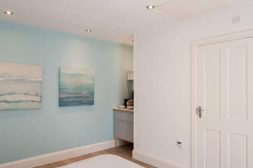 a room with white walls and a white door at Thistledene in Braunton