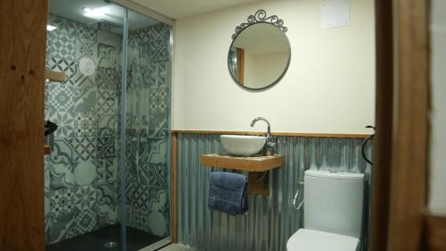 a bathroom with a sink and a shower at La Toile sous Les Étoiles in Charron