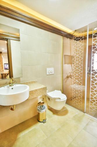 a bathroom with a sink and a toilet and a shower at Kumluk Konak Hotel in Istanbul
