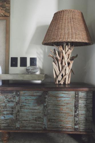 a lamp on top of a wooden dresser at Orchid House Tulum Jungle in Tulum
