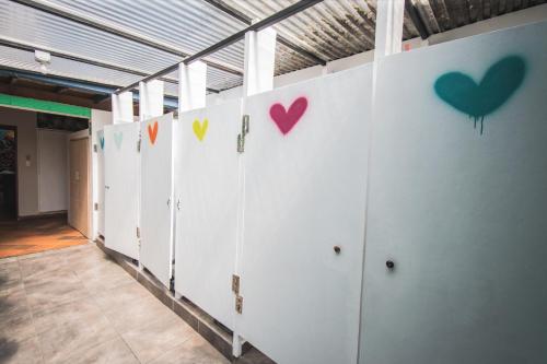 a row of lockers with hearts on the wall at Yolo Hostel Medellin in Medellín