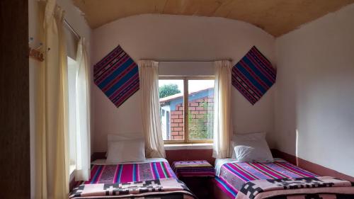 Ένα ή περισσότερα κρεβάτια σε δωμάτιο στο Luquina homestay