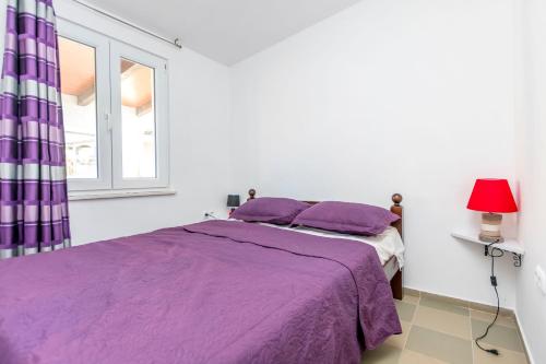 Postel nebo postele na pokoji v ubytování Apartments Lidija