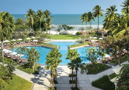 an aerial view of a resort with a pool and the ocean at The Regent Cha Am Beach Resort, Hua Hin in Cha Am