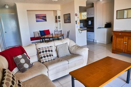 a living room with a couch and a table at Bayview Beach Holiday Apartments in Gold Coast
