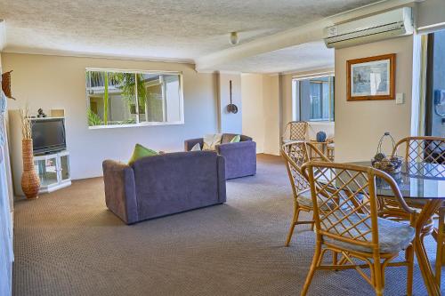 a living room with a couch and chairs and a table at Bayview Beach Holiday Apartments in Gold Coast