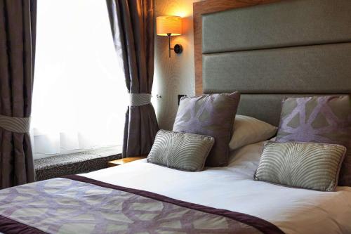 Ένα ή περισσότερα κρεβάτια σε δωμάτιο στο The George Hotel