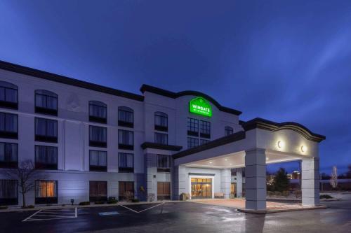 a hotel with a sign on the front of a building at Wingate by Wyndham Erie in Erie