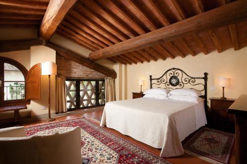 a bedroom with a large bed in a room at Monsignor Della Casa Country Resort & Spa in Borgo San Lorenzo