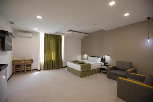 a bedroom with a bed and a couch and a chair at AnnaBella Boutique Hotel in Yerevan