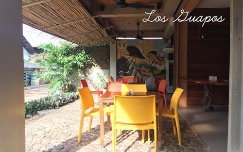 restauracja z żółtymi krzesłami i stołem w obiekcie Casa Coron Hotel w mieście Coron