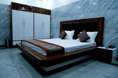 a bedroom with a large bed in a room at Hotel Amar Leela in Dehradun