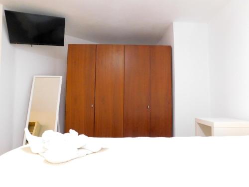 a bedroom with a dresser and a bed with a mirror at Elizabeth Suites in Kato Daratso
