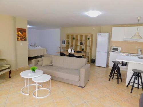 a living room with a couch and a kitchen at Elizabeth Suites in Kato Daratso