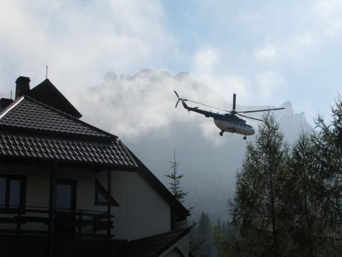 a helicopter is flying over a house at pensiunea Gabriela in Durau