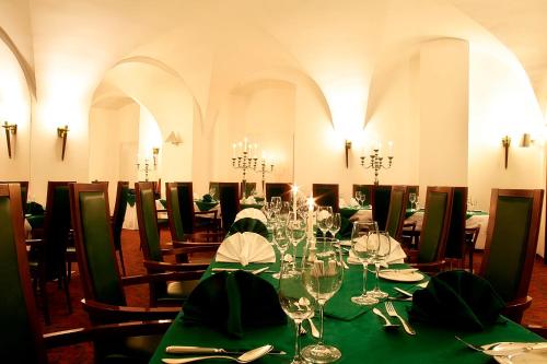 a dining room with a long table with wine glasses at Hotel Schloss Schwarzenfeld in Schwarzenfeld