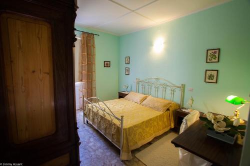a bedroom with a bed in a room with blue walls at Sassari-In in Sassari