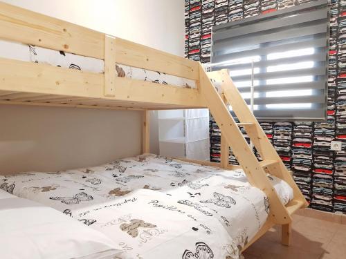 a bedroom with a bunk bed with a ladder at Colimbos accommodation, 2 min from the beach in Áyios Nikólaos
