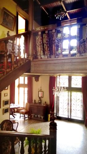 a living room filled with lots of furniture and windows at Château de la Vernède, la Grande Vernède in Saint-Rémy-de-Chargnat