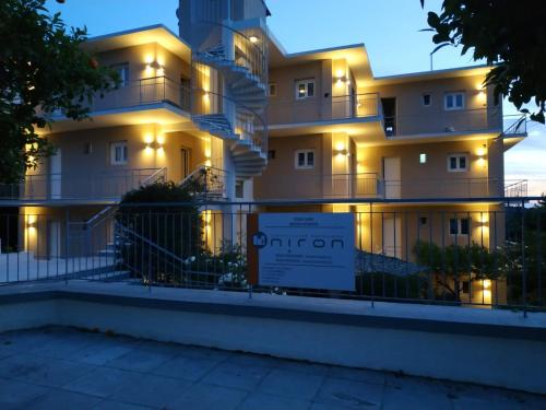 an apartment building with lights on the facade at Lilly Apartments in Athens