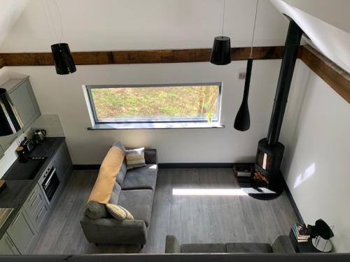 a living room with a couch and a window at Alder Cabin in Kilkenny