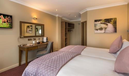 a hotel room with a bed and a desk at Limerick City Hotel in Limerick
