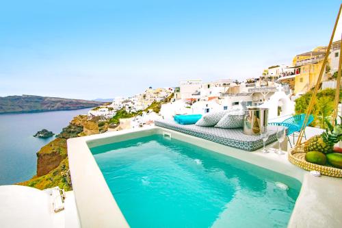 a swimming pool with a view of the water at Kaleidoscope Cave Houses in Oia